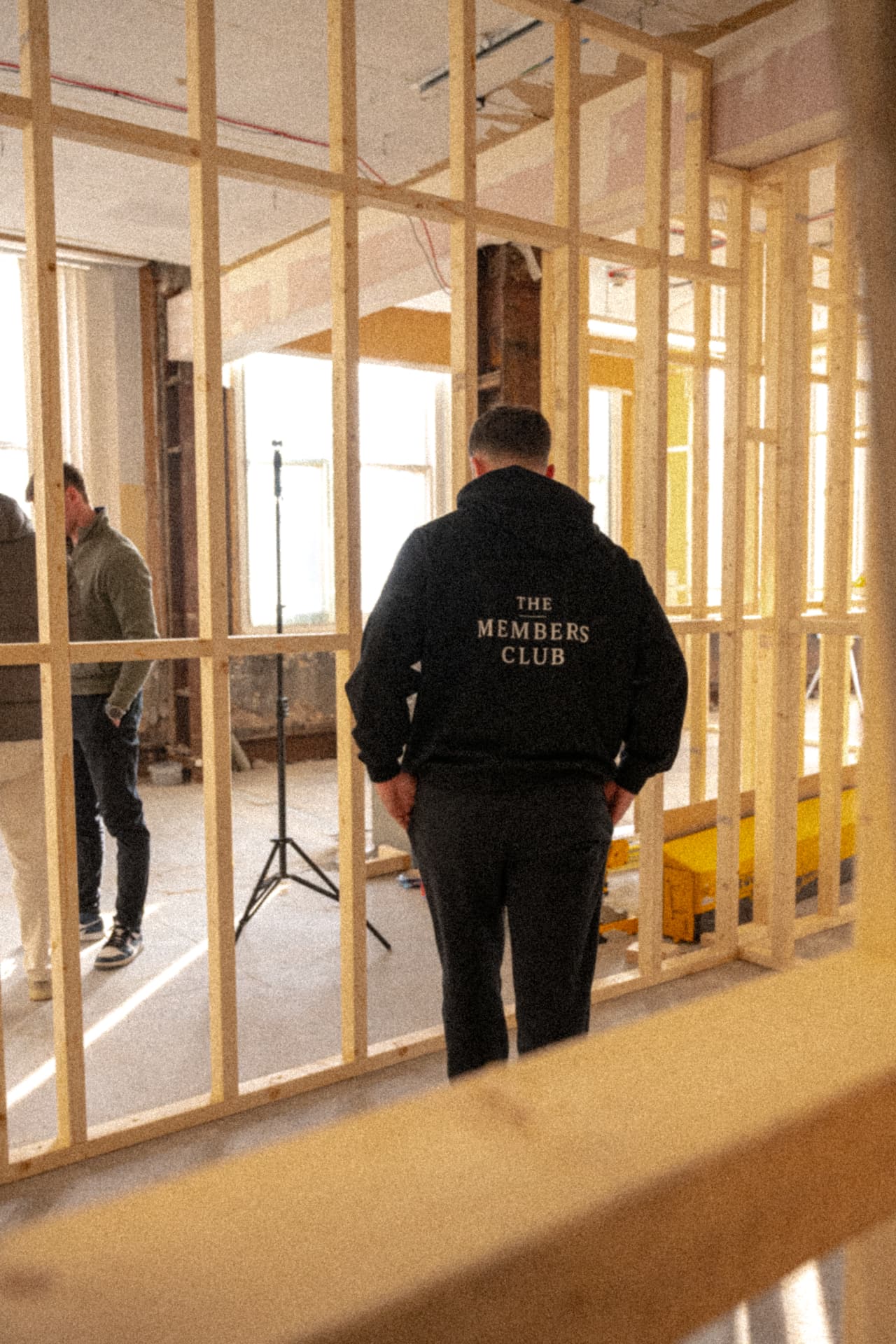 Member in TMC hoodie on a development site