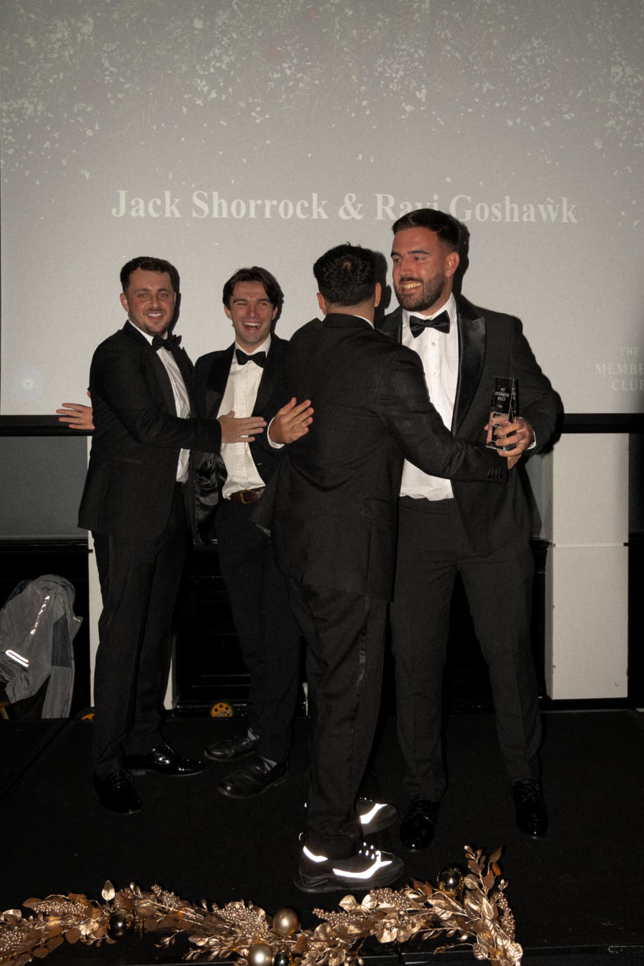 Members receiving an award on stage