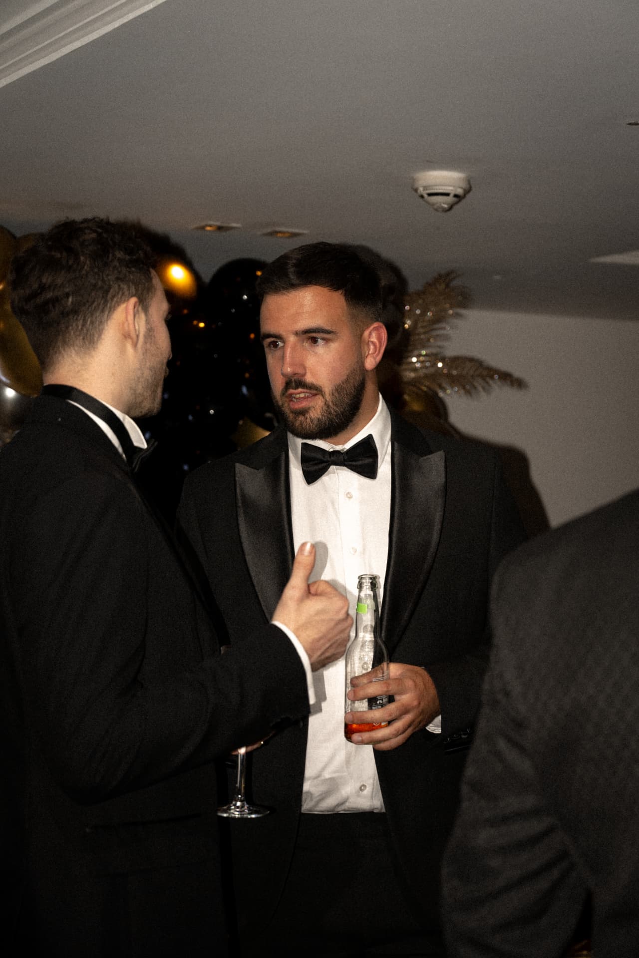 Members talking at a black tie event